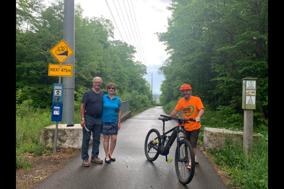 Trail Sponsor Peter MacPhail and Val Evans  with Andre Riopel at the top of the Finn Hill Site.