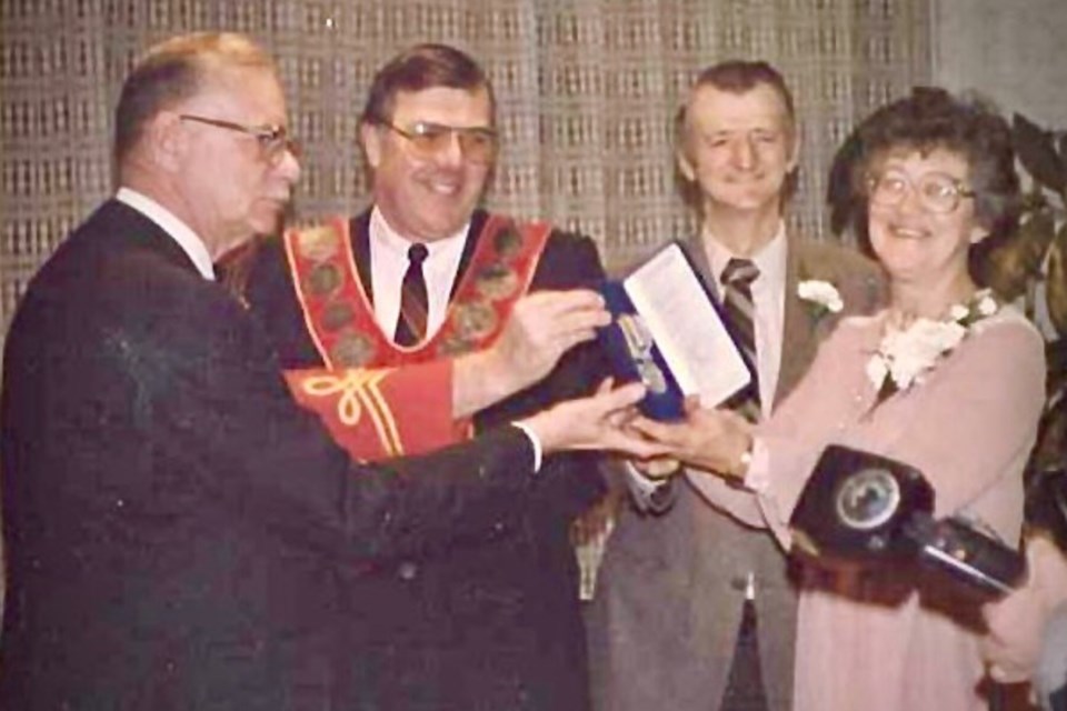 Mike and June Zuke accept the 1984 Medal of Merit from Mayor Donald MacGregor