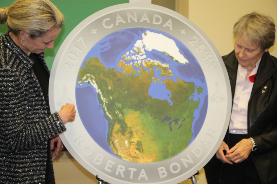 Dr. Roberta Bondar, right, joins Royal Canadian Mint president/CEO Sandra Hanington at the unveiling of an image of a special coin marking the 25th anniversary of Bondar's space shuttle flight, November 1, 2016. Darren Taylor/SooToday