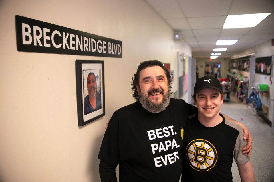 Earl Breckenridge and his son Riley pose next to the new 'Breckenridge Boulevard' sign that will be a permanent fixture at H.M. Robbins Public School. Earl may have retired but Riley has followed his father's footsteps and now works as a custodian with Algoma District School Board.