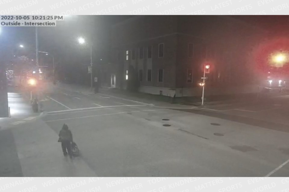 A surveillance still shows a person making their way from the scene