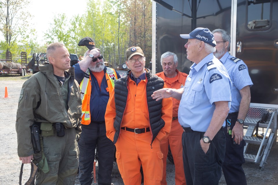 Members of the Ontario Provincial Police, Sault Search and Rescue and Coast Guard Auxiliary chat during a showcase of local search and rescue response.