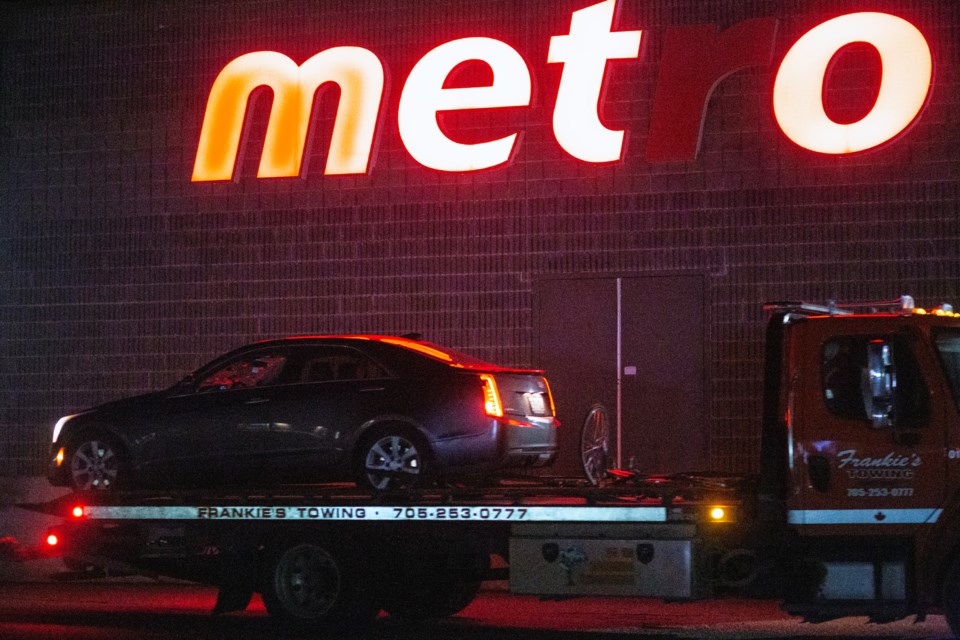 A car with a smashed windshield and a bicycle are removed from the scene of a motor vehicle collision Wednesday evening in the 200 block of Northern Avenue. Sault Police says a cyclist was seriously injured in the collision.