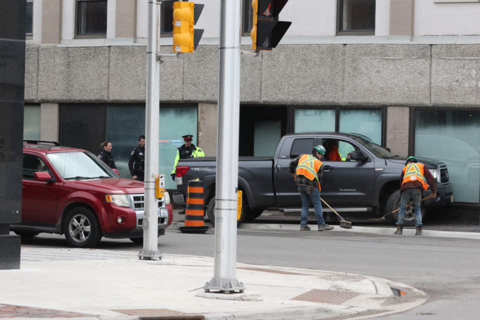 Pickup truck on sidewalk after colliding with building wall