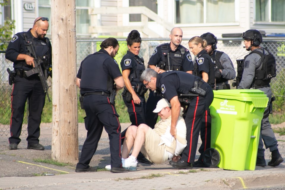 A man is taken into custody by Sault Ste. Marie police during a response to a report of a person with a weapon in the area of Chapple Avenue and Albion Street on Thursday. A spokesperson for the Sault Ste. Marie Police Service said the man who was arrested is Jonathon Morningstar, who was wanted on a Canada-wide warrant. Kenneth Armstrong/SooToday