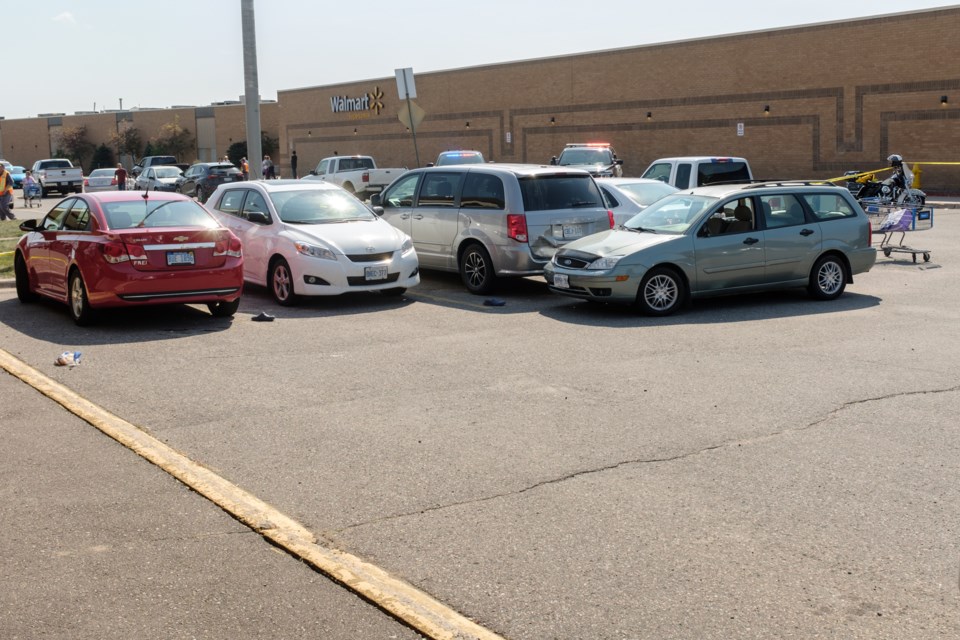 Sandals, groceries and a shopping cart are seen near a dented, green station wagon outside Station Mall today after pedestrian exiting  Walmart was struck and sustained major injuries.  Jeff Klassen/SooToday
