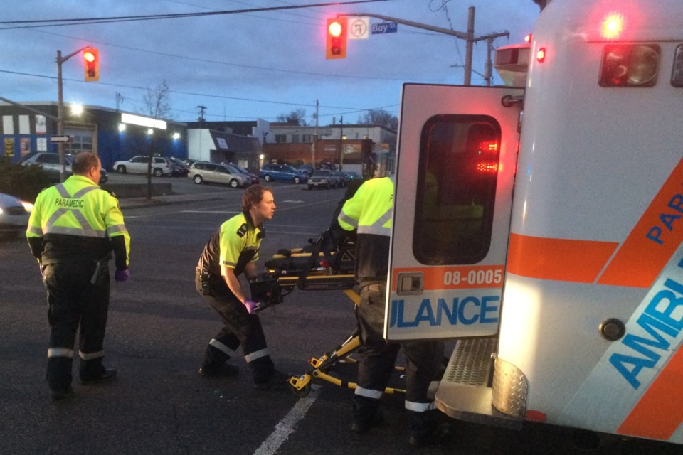 Paramedics assist a cyclist injured in a collision this evening near Tim Horton's on Bay Street. David Helwig/SooToday