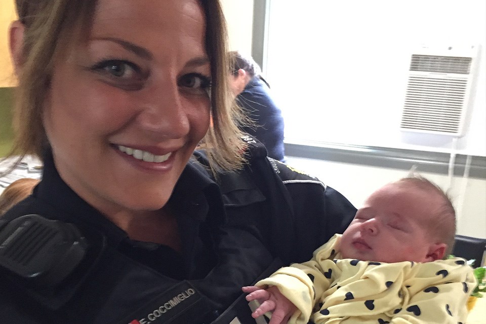 Cst. Emily Coccimiglio holds 5-day-old Allyson Newman at the Boston Ave Hub. Derek Turner/SooToday