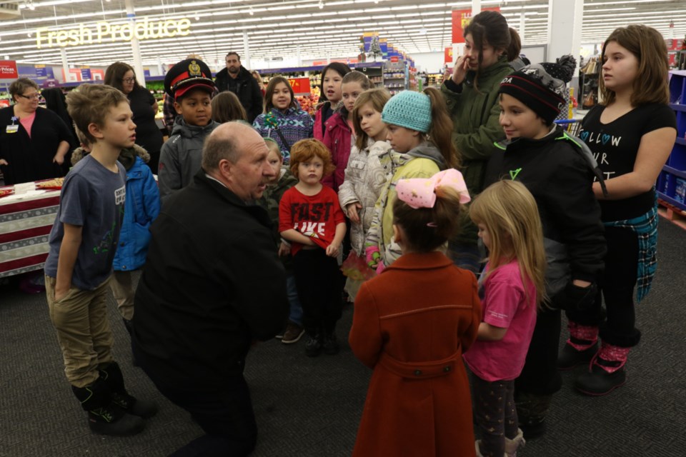 Sault Ste. Marie Police Service Chief Hugh Stevenson speaks with children before Saturday's Cops and Kids Shopping Day event. James Hopkin/SooToday