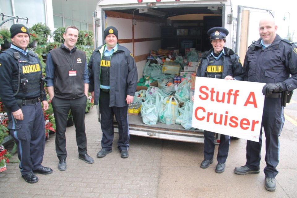 OPP auxiliary officers Steve Whitfield, Luke Elwgren, Ariella Arbus and Jeff Dewar with Chris Rome, Rome’s Independent Grocer owner (second from left) at the annual OPP Stuff a Cruiser food drive at Rome’s, Dec. 2, 2017. Darren Taylor/SooToday 