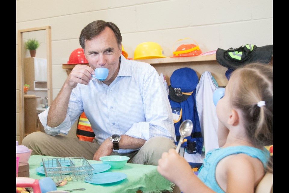 Federal Finance Minister Bill Morneau shares a cup of tea with Daniella Greco, age two, during a meet and greet August 10, 2016 at Early Years/Best Start Hub Holy Cross School. Kenneth Armstrong/SooToday