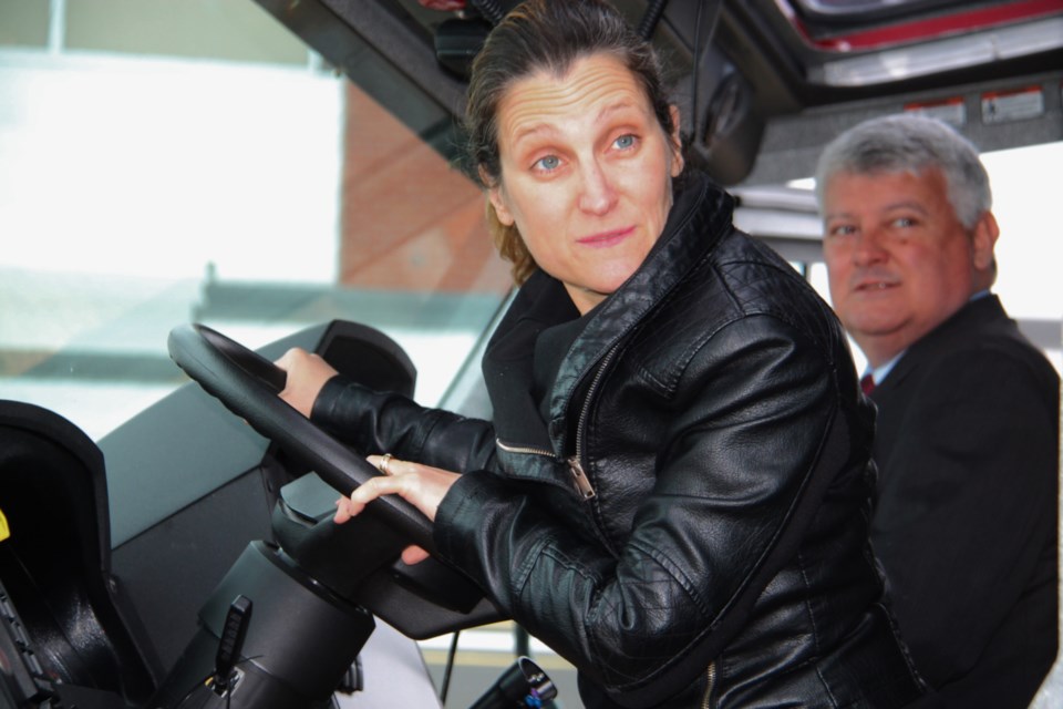 Minister of Foreign Affairs Chrystia Freeland at the wheel of a Sault Ste. Marie Airport fire truck, with Sault MP Terry Sheehan at rear, the airport receiving federal government funding for a new alarm system, April 18, 2019. Darren Taylor/SooToday 