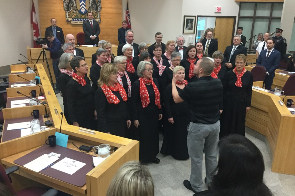 The ends of the skillfully sawed-off councillor desks were clearly visible at Monday's inaugural City Council meeting. Shown is the Algoma Festival Choir performing O Canada. David Helwig/SooToday 