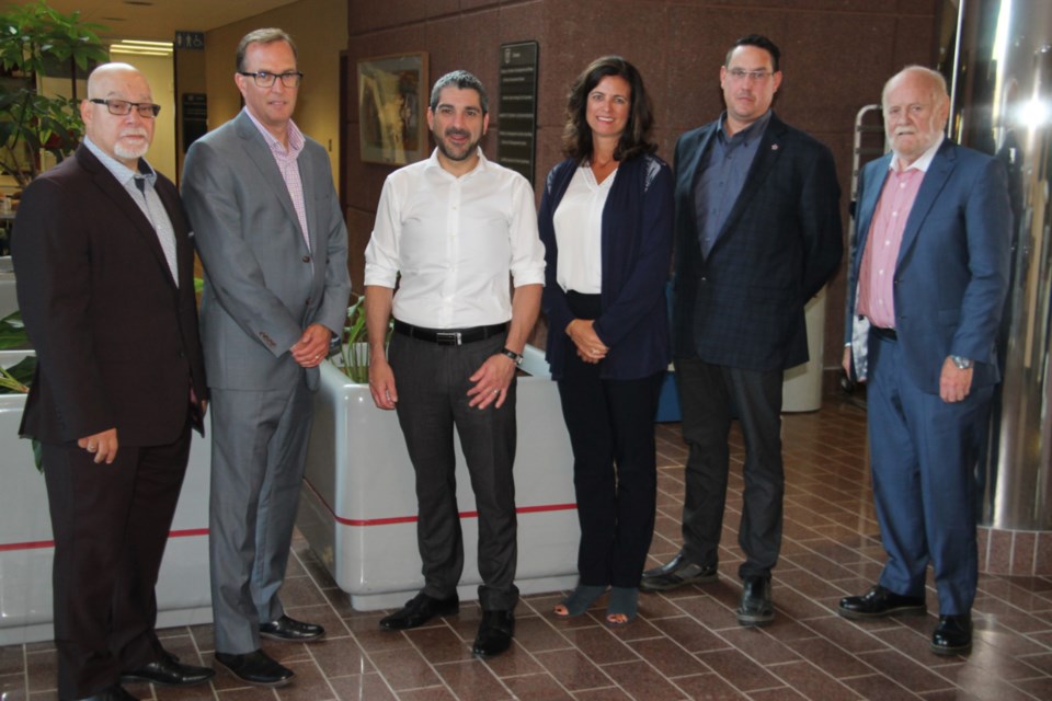 John Febbraro, Sault Ste. Marie Economic Development Corporation (EDC) manager of business development, Dan Hollingsworth, EDC executive director, Sault MPP Ross Romano, Brenda Stenta, Algoma Steel communications manager, Dave Rector, Rector Machine Works president, and Ron Common, Sault College president, at a provincial government funding announcement designed to give Sault and northern Ontario companies a chance to get involved in manufacturing components for Canada’s national defence industry, Sept. 9, 2019. Darren Taylor/SooToday