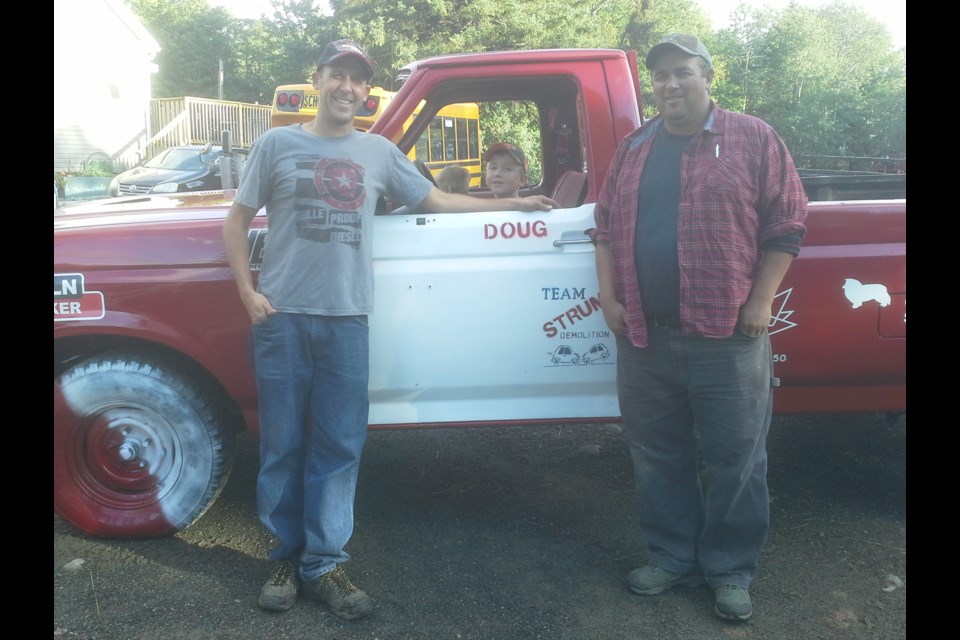 Doug Strum, Right: Dave Bordeleau with Doug's 6 year old son Russell and 2 year old Jackson in the truck. Photo courtesy Doug Strum