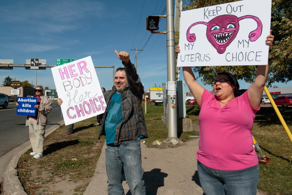 Pro-choice counter demonstrators hold signs and cheer as cars honk at them in support at the 2017 Life Chain Sault Ste. Marie anti-abortion demonstration at Great Northern Road and McNabb Street on Sunday. Jeff Klassen/SooToday