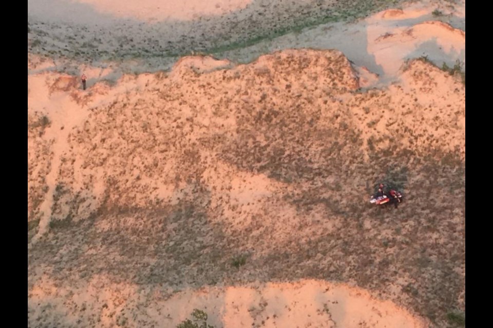 First responders from Glen Lake Fire Department in Upper Michigan rescue a 5-year-old boy in Sleeping Bear Dunes National Lakeshore during a multi-agency search, June 29, 2018. A helicopter crew from Coast Guard Air Station Traverse City located the boy after being requested to search from the air. (U.S. Coast Guard photo by Air Station Traverse City)
Photo by Master Chief Petty Officer Alan Haraf 
U.S. Coast Guard District 9 
