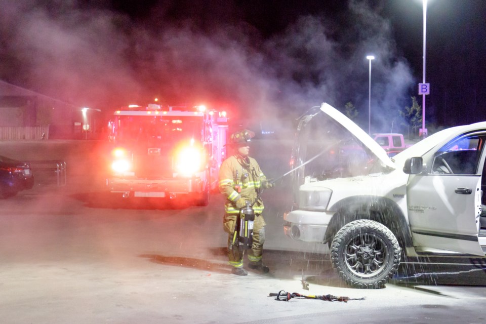 The Sault Ste. Marie Fire Department used a water-can fire extinguisher to put out a fire in the engine area of a white Dodge Ram pickup truck that was parked in front the new Meijer Supercentre in Sault, Mich. on Saturday, Sept. 30. Jeff Klassen/SooToday