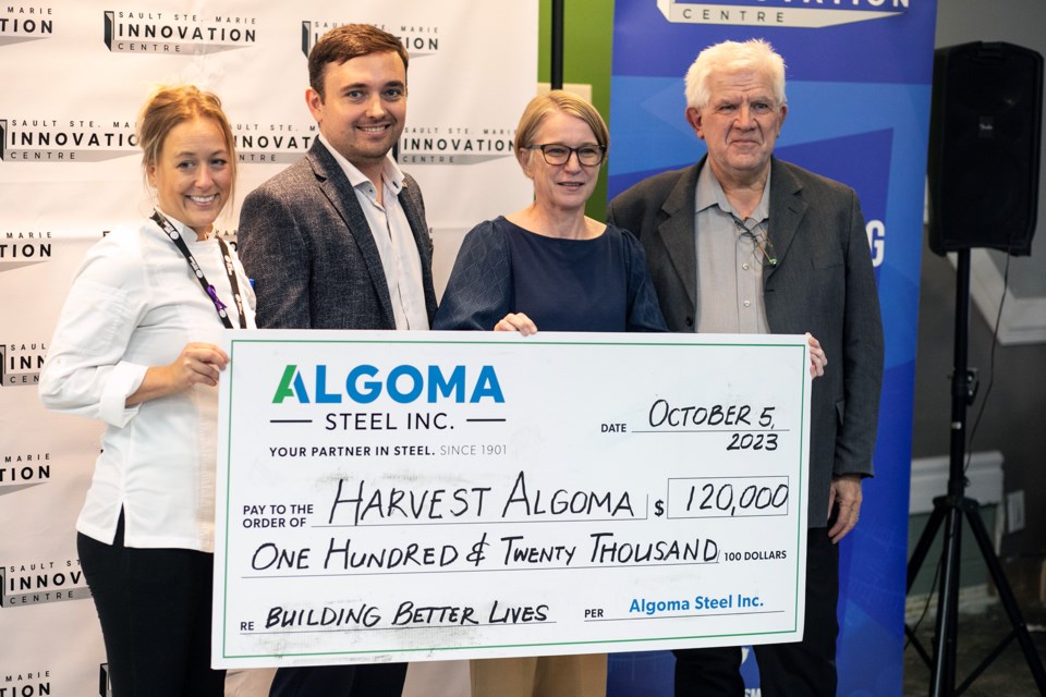 L-R Jane McGoldrick, David Thompson, Danielle Baker and Peter Bruijns hold an oversized cheque from Algoma Steel in support of Harvest Algoma.