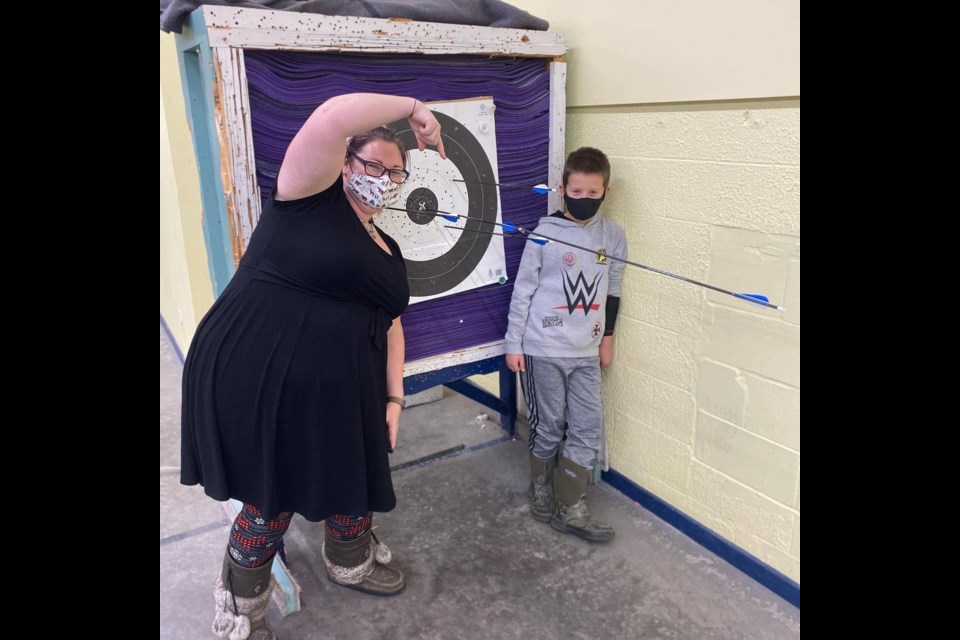 Lana Perry, archery coach and instructor, and Connor Burtch after Connor made a rare Robin Hood bullseye, hitting and splitting another of his own arrows already sitting in the bullseye on the target at the Algoma Rod & Gun Club, Dec. 2, 2020. Photo supplied