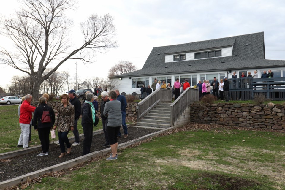 People walk from Mulligan's Irish Pub to a flagpole where the Sault Golf Club raised a flag to commemorate the club's 100th anniversary. James Hopkin/SooToday