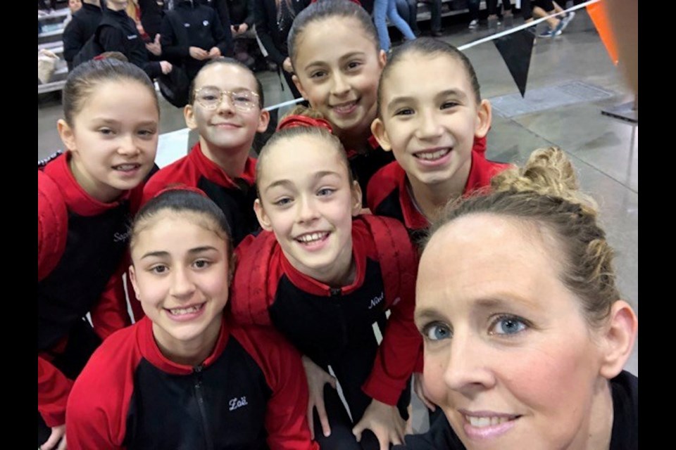 Kim Bonnell with a group of young gymnasts. A promising young athlete herself, Bonnell has embraced coaching. Photo supplied