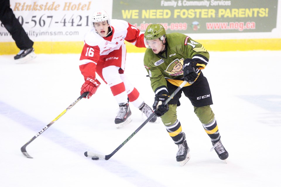 North Bay Battalion's Zach Poirier (14) handles the puck under pressure by Morgan Frost of the Soo Greyhounds during a game October 8, 2016 at the Essar Centre in Sault Ste. Marie. Kenneth Armstrong/SooToday