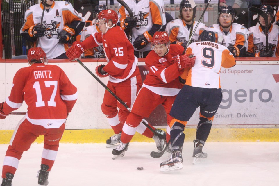 Soo Greyhounds' Mac Hollowell (11) collides with Jack Phibbs of the Flint Firebirds during Game 2 of their first round playoff series played March 25, 2017 at the Essar Centre in Sault Ste. Marie. Kenneth Armstrong/SooToday