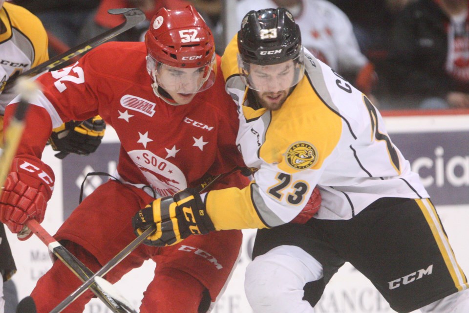 Soo Greyhounds forward Jack Kopacka collides with Zachary Core of the Sarnia Sting during game 4 of their playoff series, played tonight at the Essar Centre. Kenneth Armstrong/SooToday