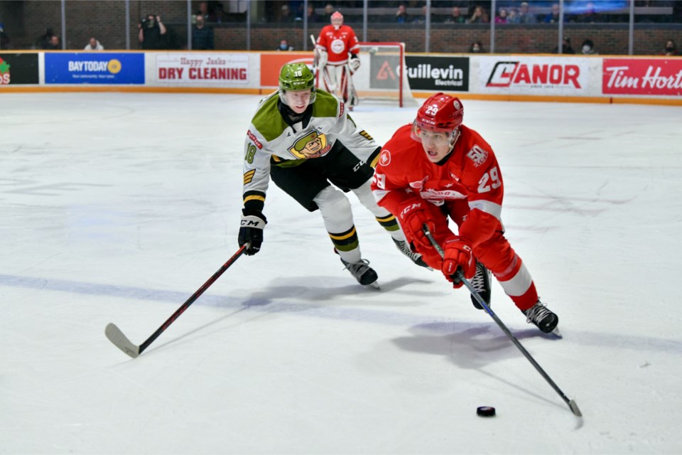 Soo Greyhounds defenceman Kirill Kudryavtsev skates the puck up ice against the North Bay Battalion on Dec. 9, 2021.