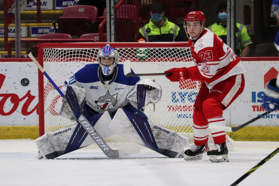 Soo Greyhounds forward Rory Kerins looks to deflect a shot past Sudbury Wolves goaltender Mitchell Weeks in a game at the GFL Memorial Gardens on Feb. 23, 2022.