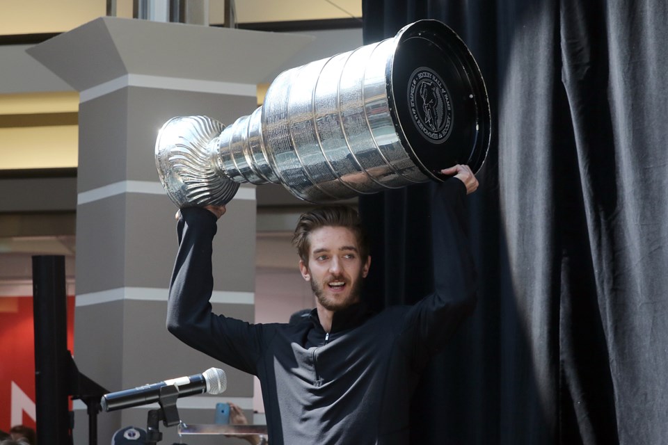 Former Soo Greyhounds goalie Matt Murray hoists the Stanley Cup at Intercity Shopping Centre this morning in Thunder Bay. Thousands turned out as Murray brought the Cup to his hometown. Leith Dunick/tbnewswatch.com