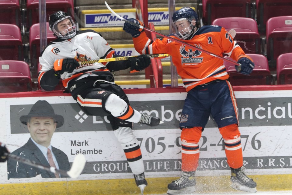 Soo Thunderbirds forward Michael Chaffay hits a Hearst Lumberjacks player during the opening game of the NOJHL final on May 1, 2022.