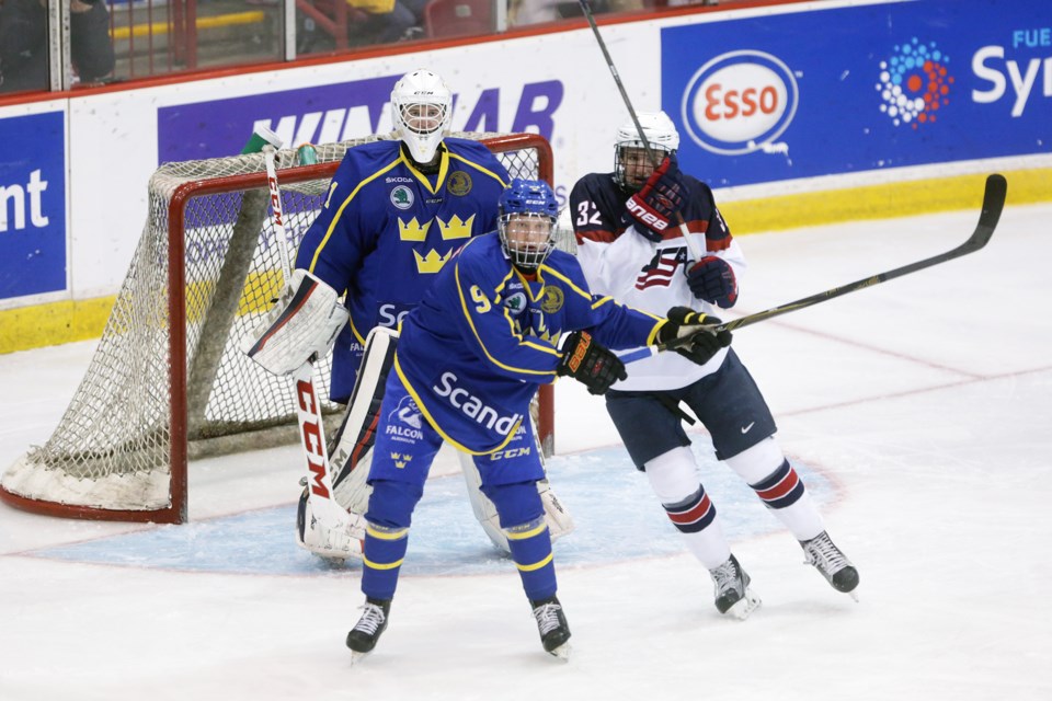 Team Sweden's Rasmus Sandin and Jack DeBoer of Team USA fight for position in front of goaltender Olof Lindbom during a quarter-final game played Nov. 3, 2016. Sweden went on to defeat USA 4-3 to advance in the 2016 World Under-17 Challenge tournament. Kenneth Armstrong/SooToday