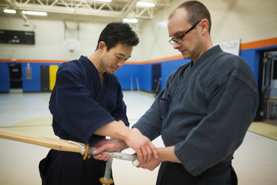 Hyun-June Choi instructs Brian Lampe on form during a kendo seminar held January 23, 2016 at St. Ann School in Sault Ste. Marie. Kenneth Armstrong/SooToday