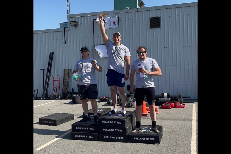 Jared Musgrove of Garden River First Nation (centre) won his first gold medal as a Strongman at the Battle at the Brink Strongman competition in Niagara Falls, June 3, 2023. 