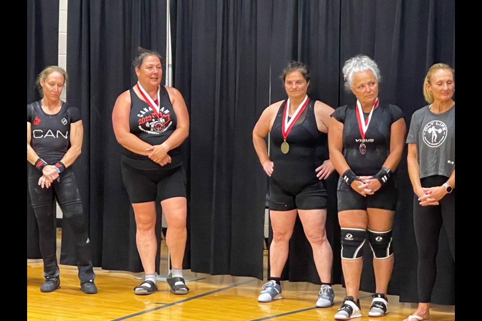 Michelle Pearson of Echo Bay and Trish Barber of Sault Ste. Marie, second and third from left, at a provincial weightlifting qualifier in Feb. 2023. 