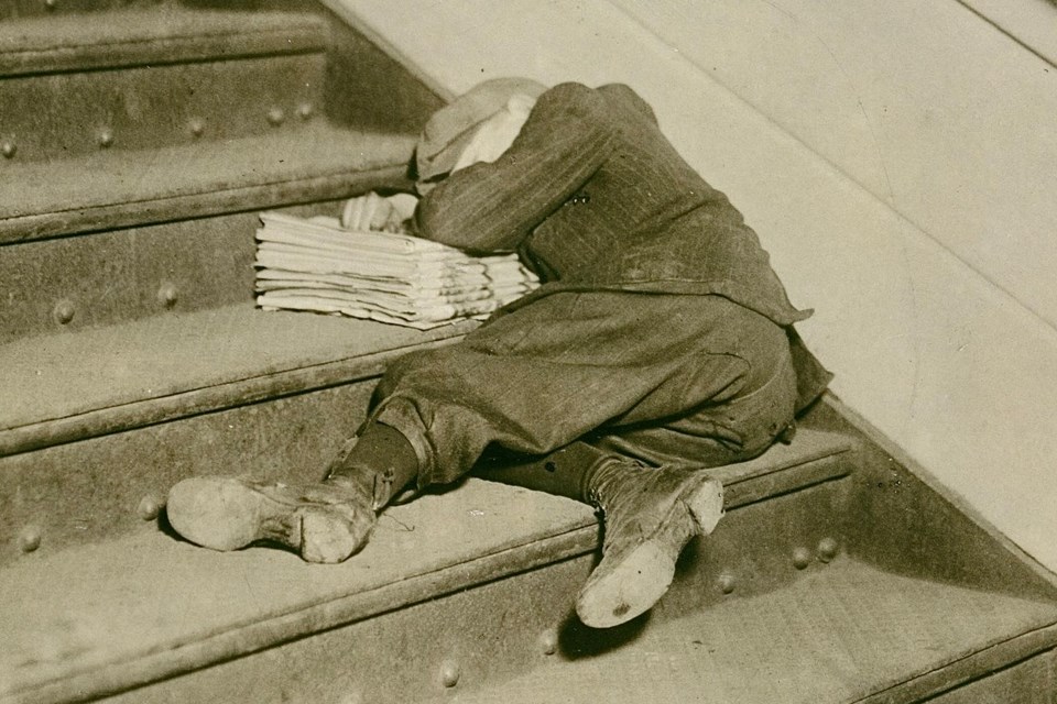 Exhausted newspaper carrier, photographed in 1912 in Jersey City, New Jersey