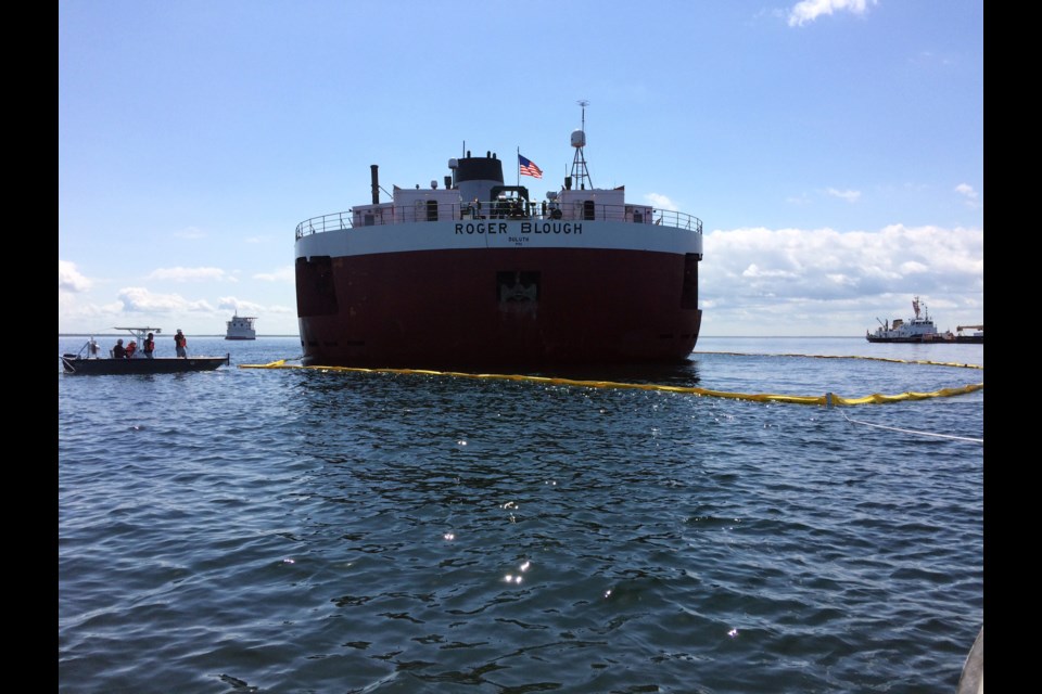 Responders place protective boom around the stern of the motor vessel Roger Blough, which ran aground on May 27, near Gros Cap Reefs Light in Lake Superior,  May 30, 2016. Responders deployed the boom strictly as a preventative measure around the location of the Blough's fuel tanks. (U.S. Coast Guard photo by Lt. Cmdr. Merridith Morrison)