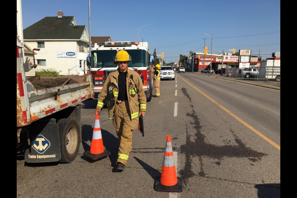 Firefighters clean up a transmission fluid spill on Wellington Street West on Tuesday, Aug. 15, 2017. Darren Taylor/SooToday