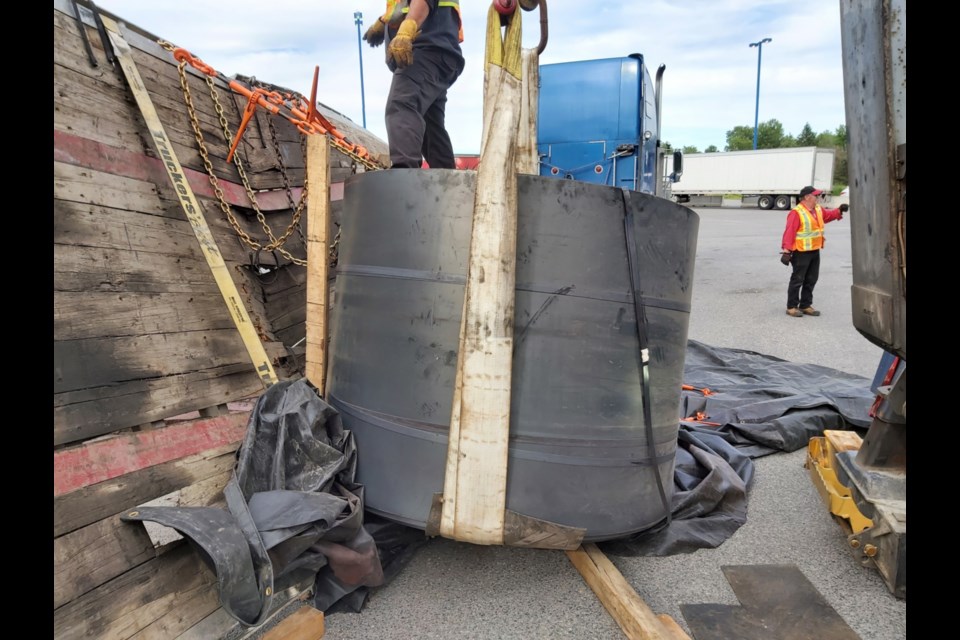 A steel coil, weighing more than 50,200 pounds, on the way from Algoma Steel to Toronto, fell to the pavement of the Husky/Esso truck stop, the flatbed trailer carrying it badly buckled, June 29, 2022.