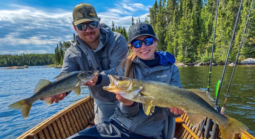 two-happy-guests-holding-caught-fish-aspect-ratio-850-465