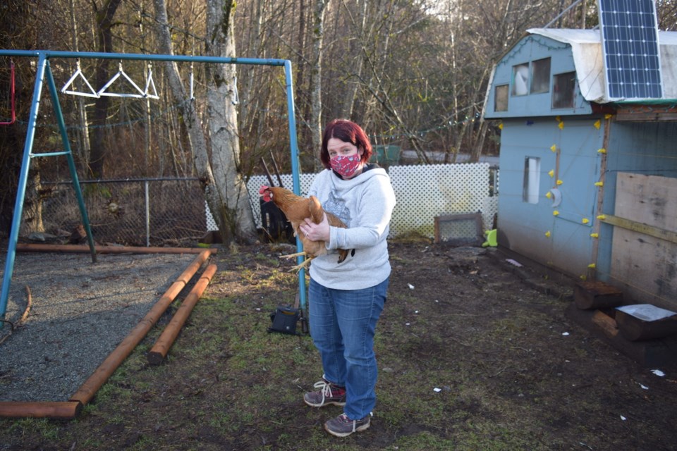 Erin Schaber with a hen. 