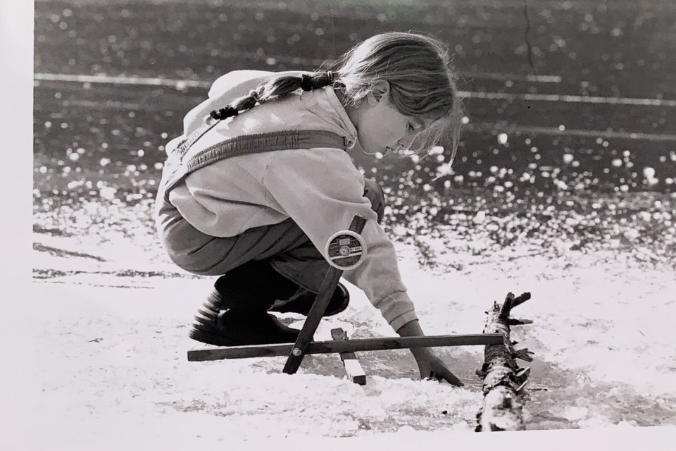 Youth leader ice fishing on Cat Lake. 