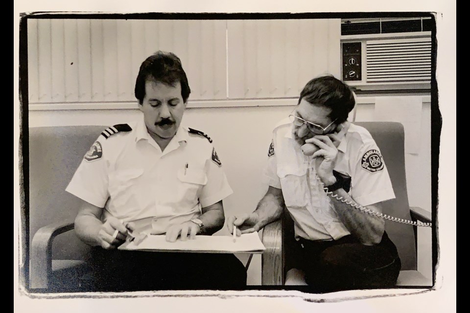 Ambulance attendants: Bob Singer and Larry Law work out a staffing schedule for the holiday season. Attendants work four days on and four days off. Shift work allows you to live your life on your own terms, not by the clock, says Larry. 