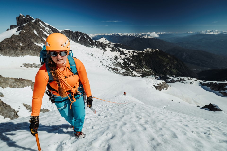 A local climbs the steep snow ridge on the North Face of Serratus Mountain in the Tantalus mountain range  Watch for avalanche conditions when in the alpine. T