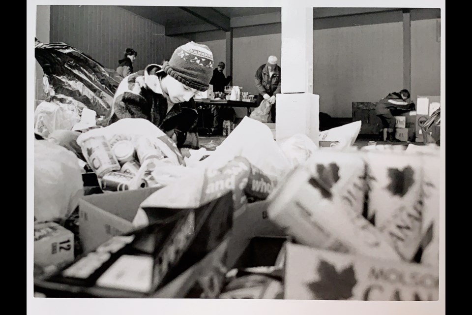 The back of this photo says Andrew Speidel works on Saturday at the Scout Bottle Drive at Squamish Elementary. 