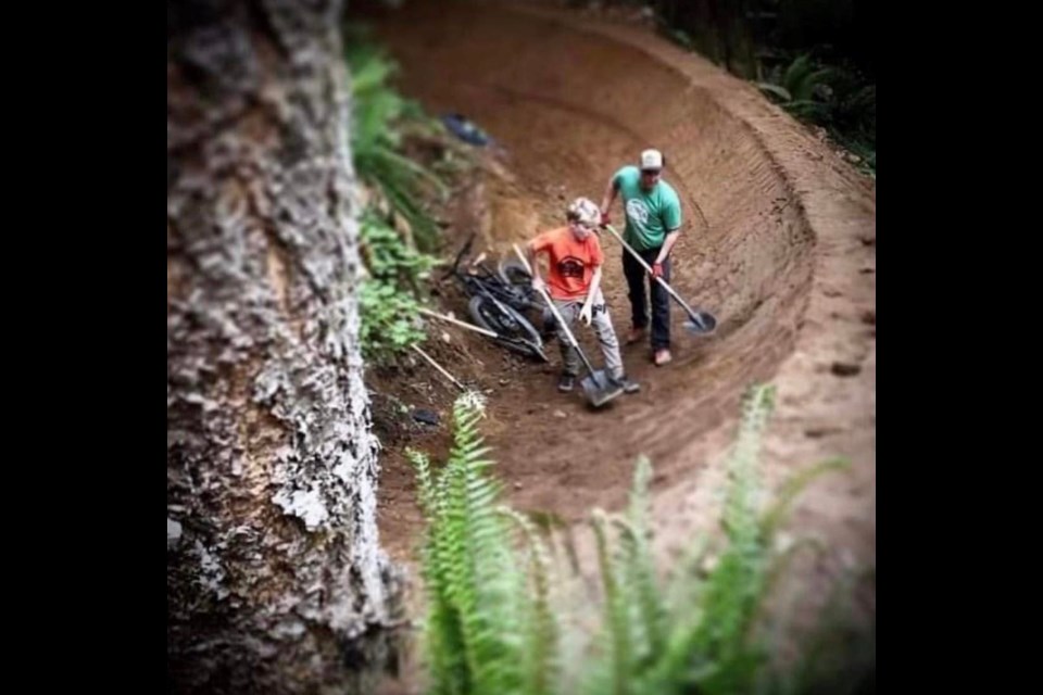 The late Dave Reid and son, Griff working on a Squamish trail. 