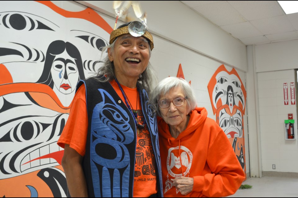 Xwalacktun and mom, Gwen Harry at Brennan Park Recreation Centre in front of one of his art pieces for Orange Shirt Day/National Day for Truth and Reconciliation in 2022.