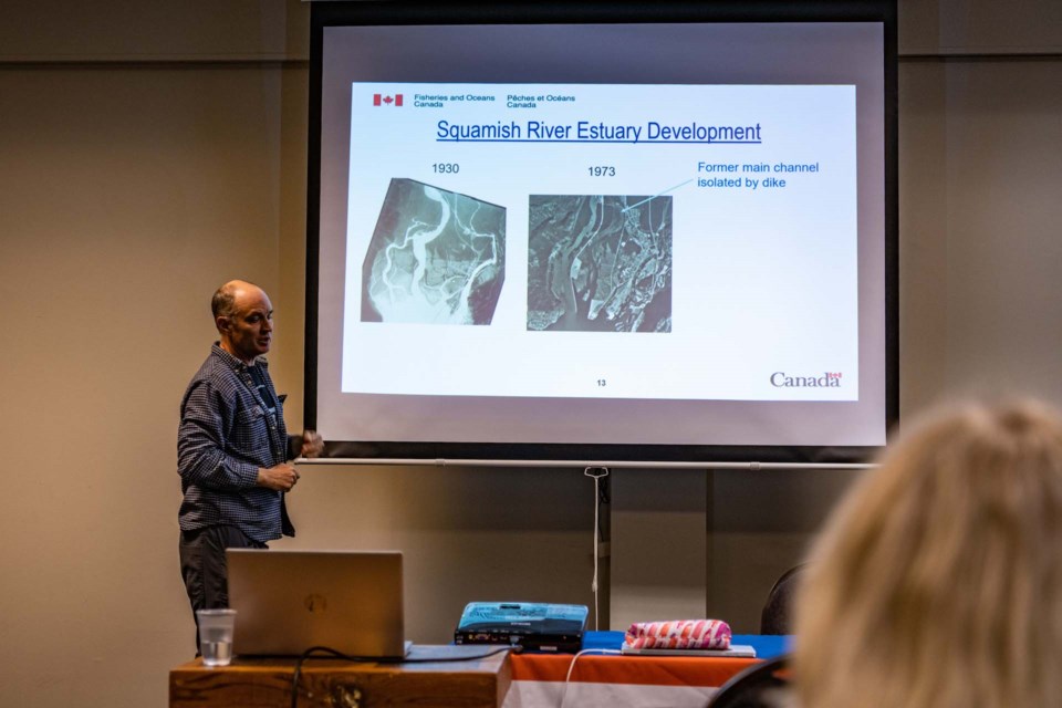 Murray Manson, a biologist with DFO, presents at the public meeting on April 11. 